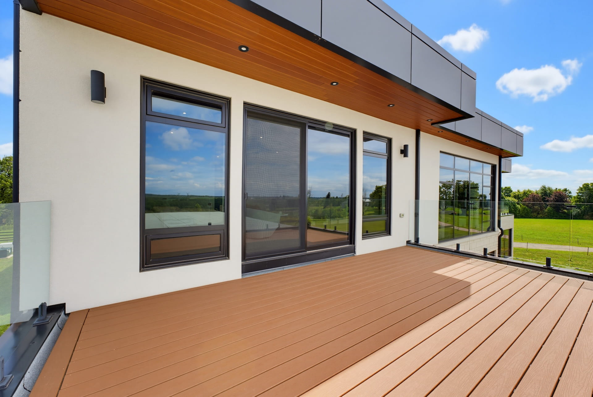 Covered cedar terrace off a contemporary home overlooking open countryside
