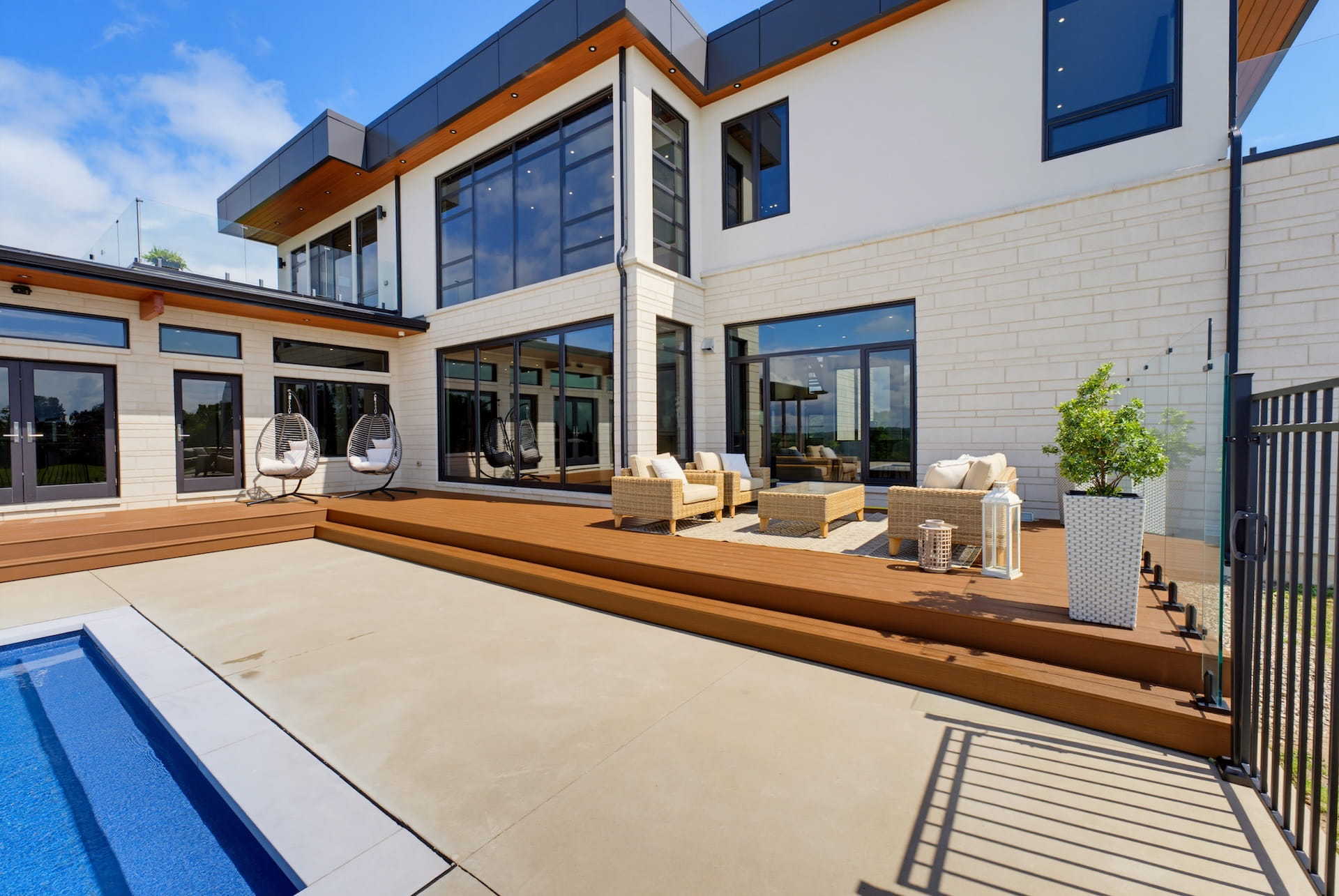 Rear elevation of a contemporary Oakville estate with a covered terrace and swimming pool