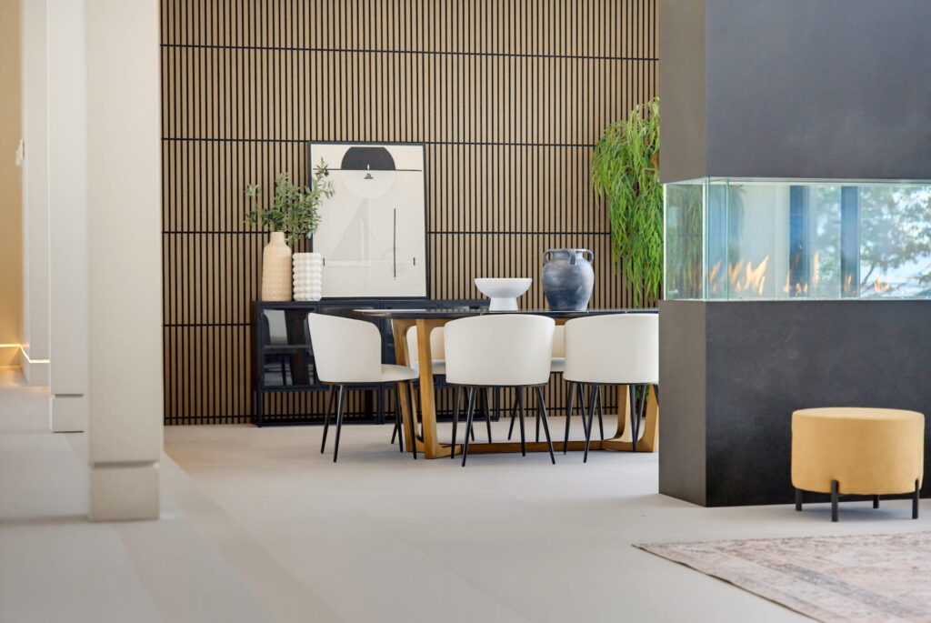 Dining room of a custom Oakville residence with slatted oak panelling and a linear gas fireplace
